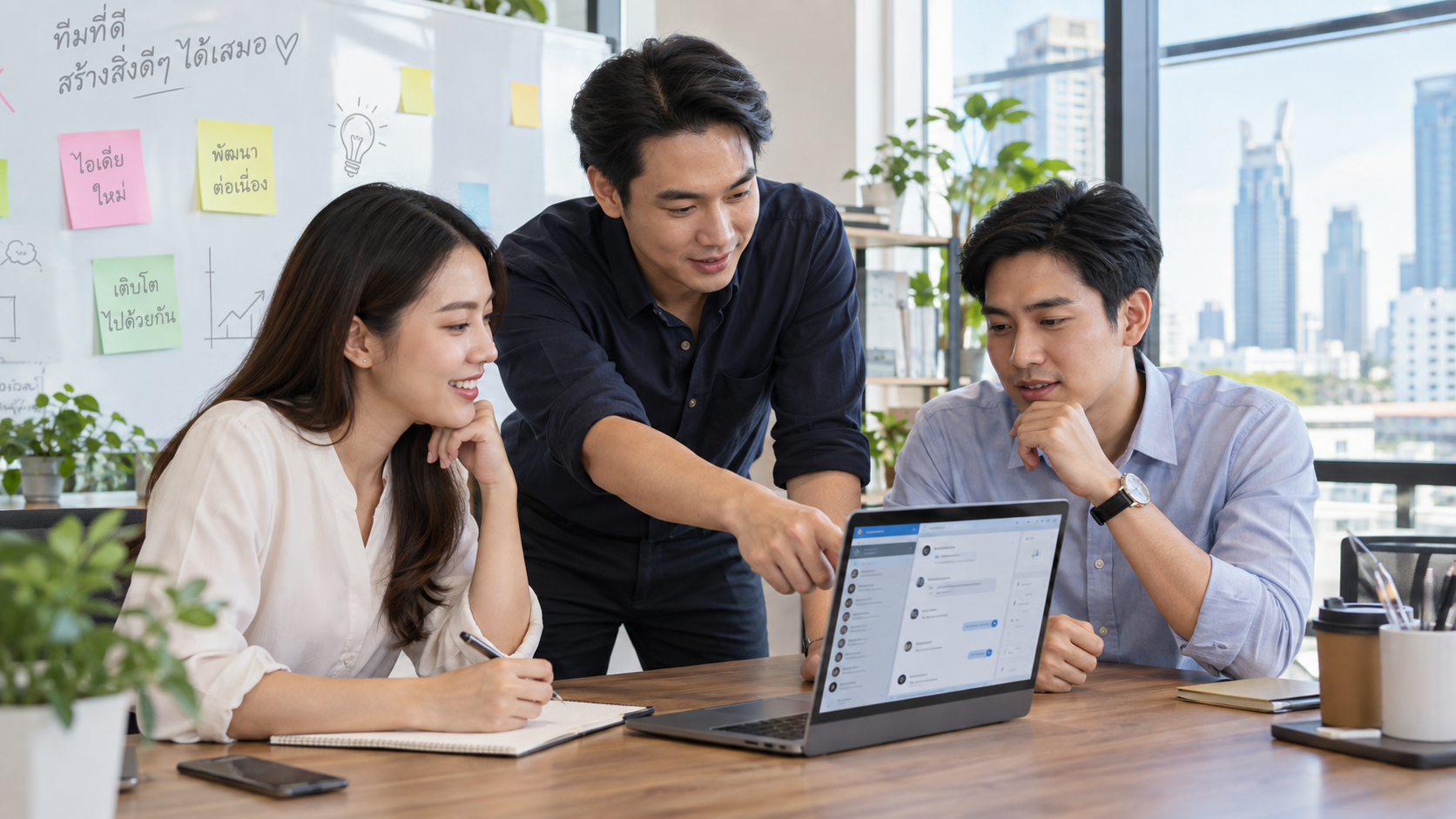 หัวหน้าทีมเทรนพนักงานใหม่ตอบแชทลูกค้าที่ออฟฟิศในไทย